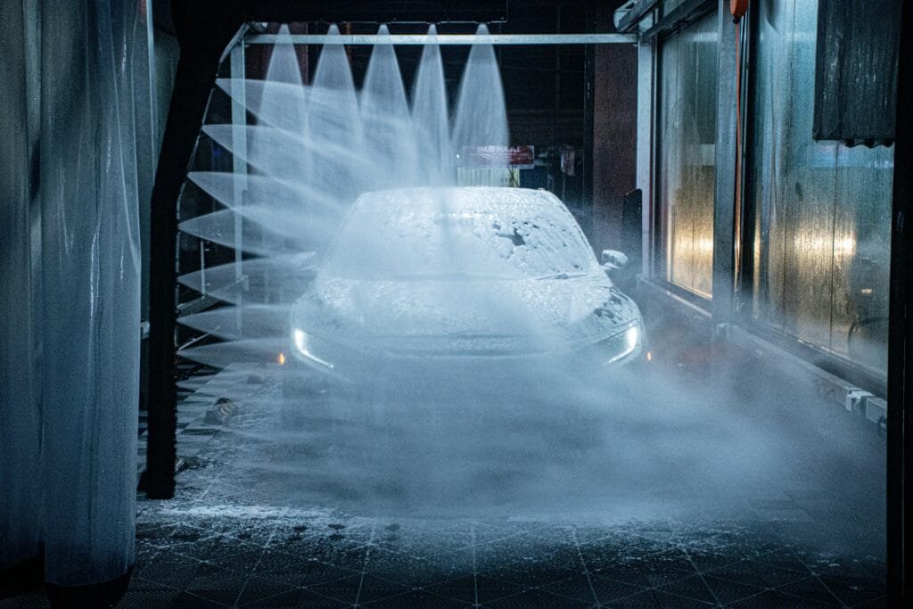 Car passing through an automatic wash tunnel