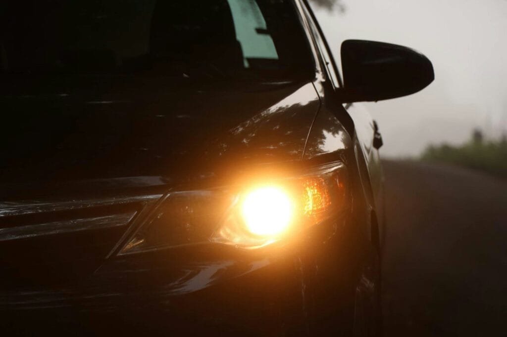 Foggy, hazy car headlight at night