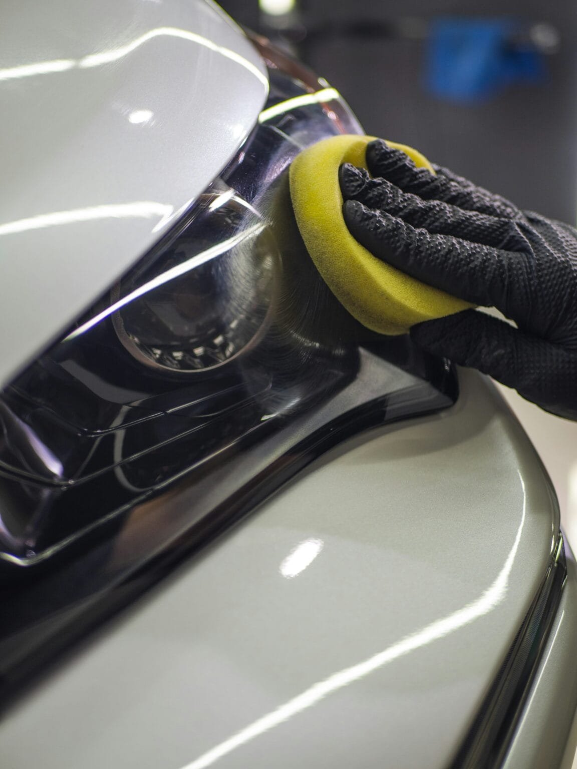 Applying spray wax to a car's painted surface