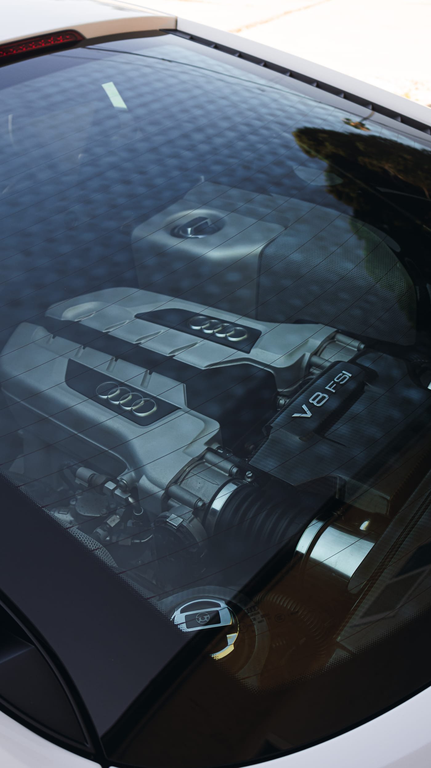 Clean V8 engine bay after detailing, reflected in the rear glass