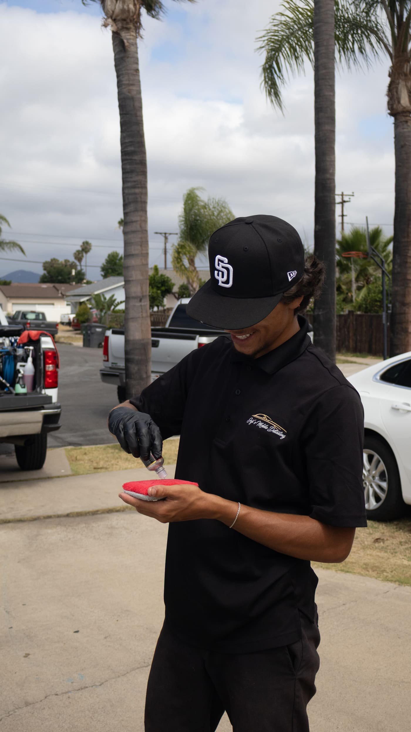 Technician applying ceramic coating product in La Mesa, CA, Joji's Mobile Detailing