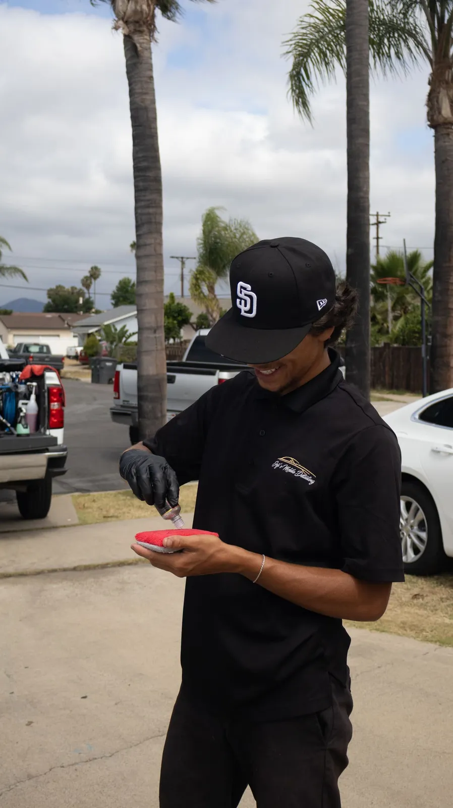 Technician applying ceramic coating product in Coronado, CA, Joji's Mobile Detailing