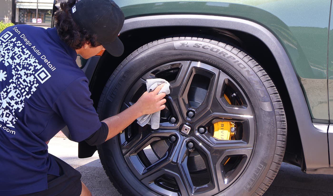 Technician detailing a wheel in La Mesa, CA, Joji's Mobile Detailing