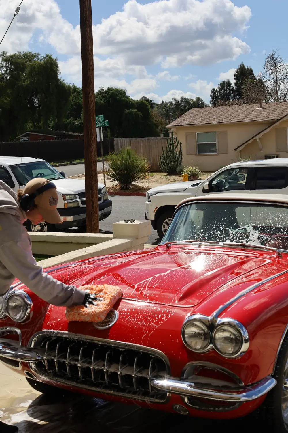 Coronado paint correction: technician hand washing a red classic Corvette