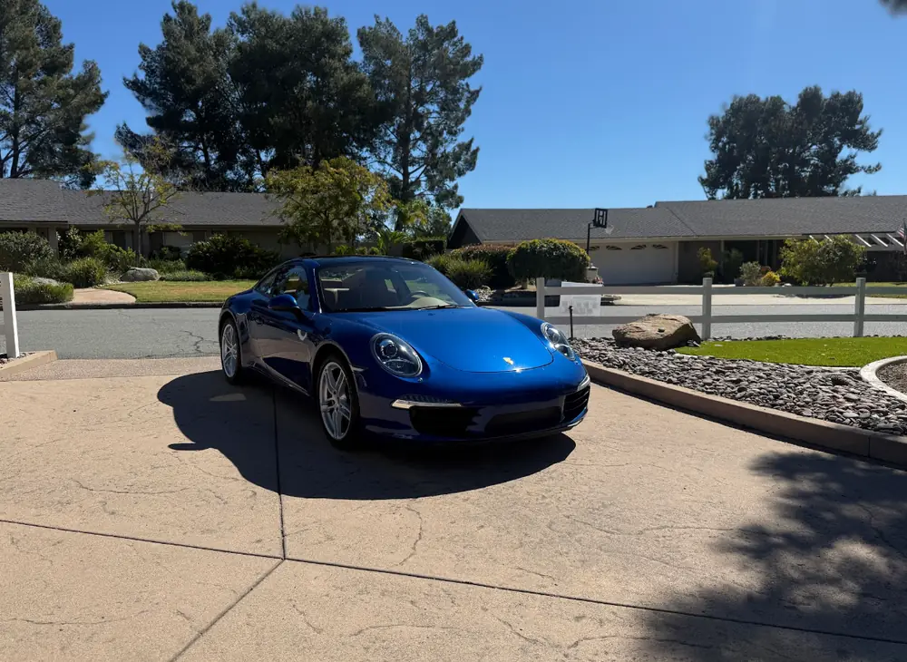 La Jolla paint correction: blue Porsche 911 parked in a driveway