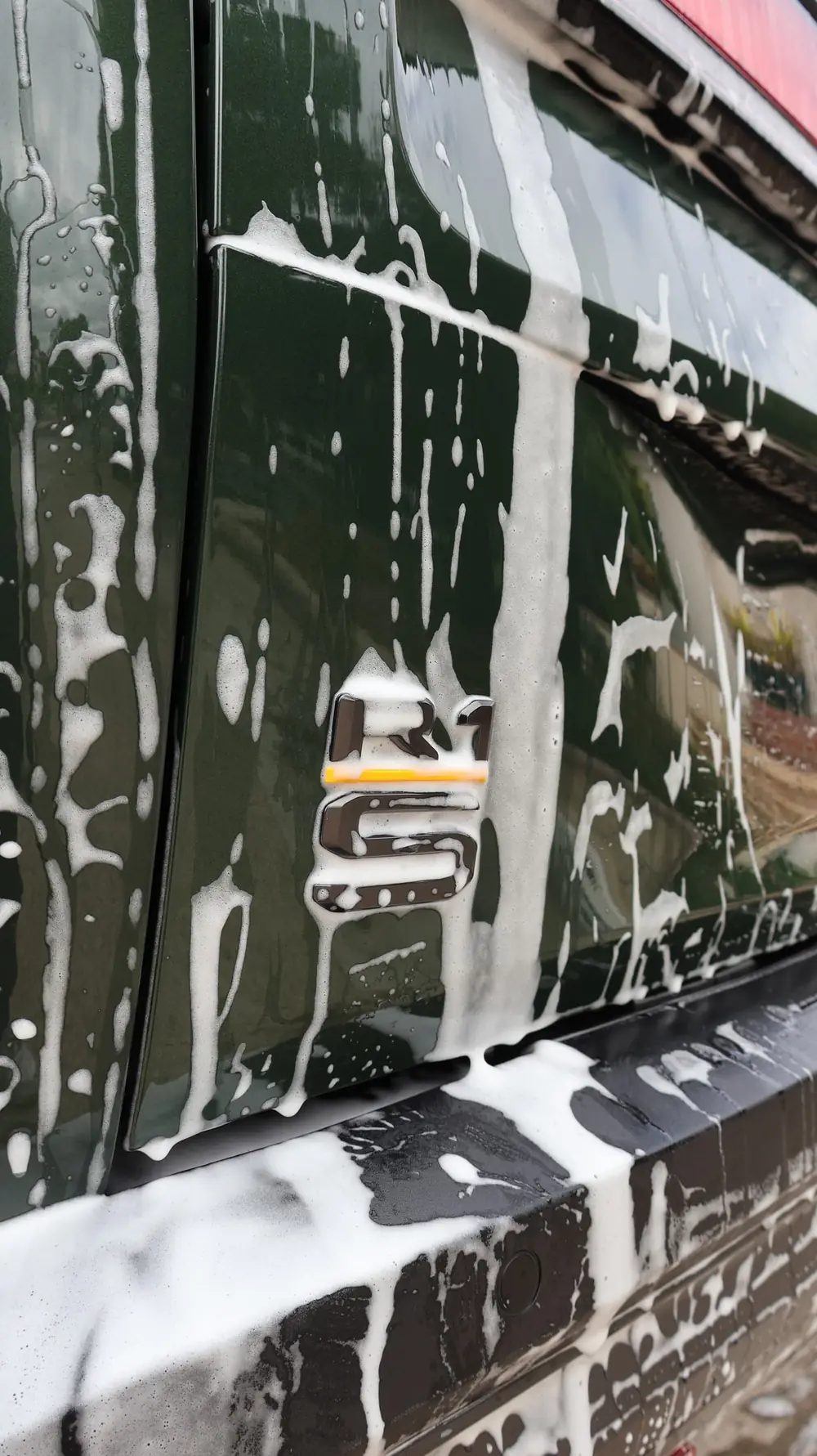 Mission Beach paint correction: foam covering the side of a Land Rover Defender during a hand wash
