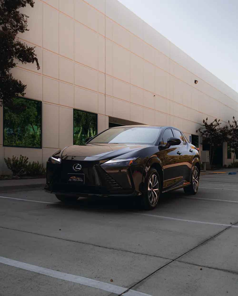 Mission Valley paint correction: glossy black Lexus parked beside a building
