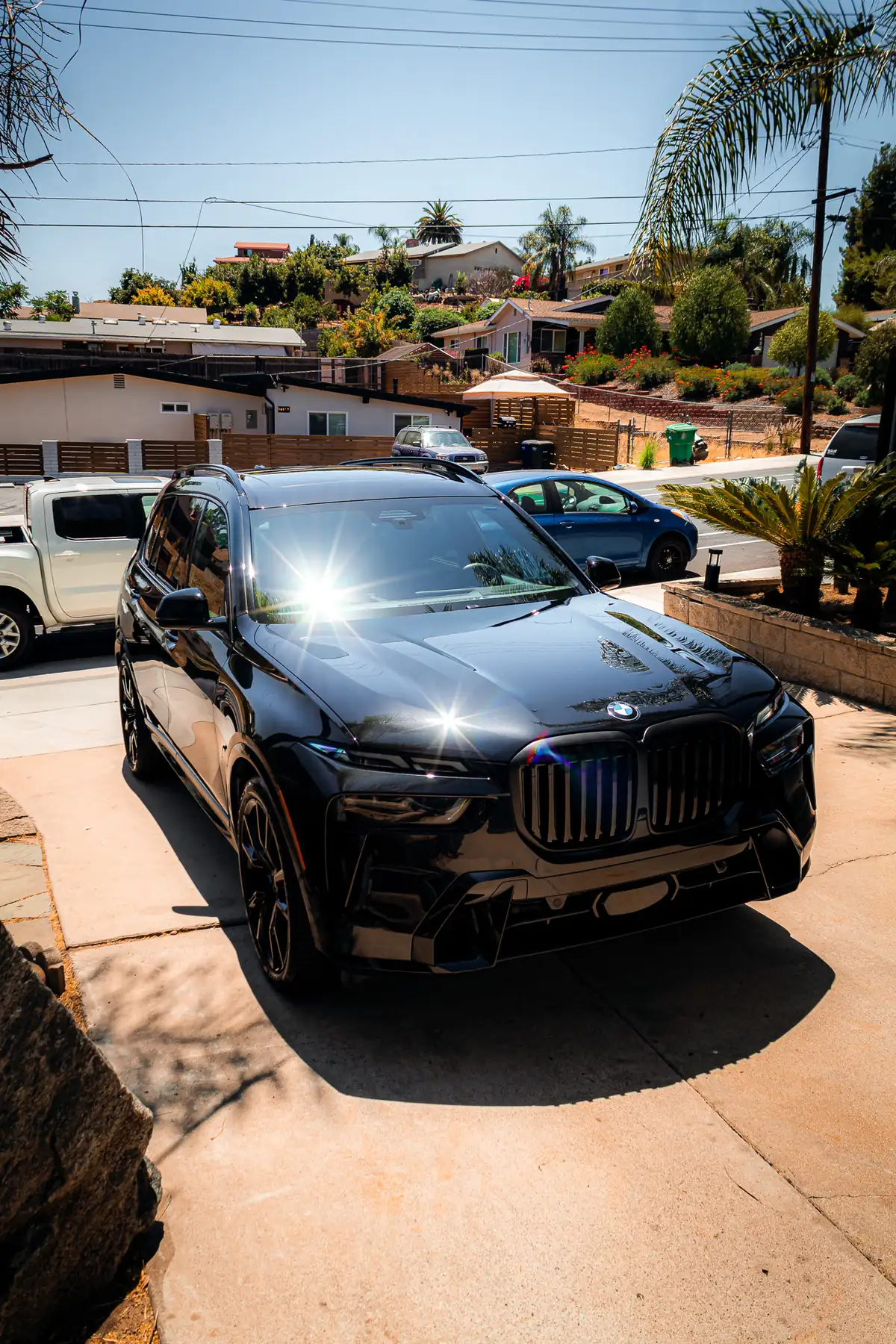 Santee paint correction: glossy black BMW X7 on a sunny driveway